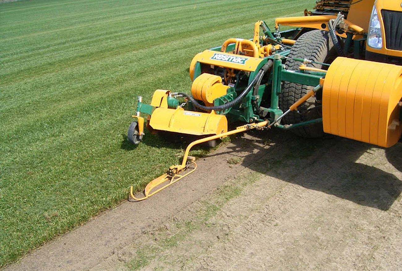 Turf harvester cutting rolls of grass on the River Oak Turf farm